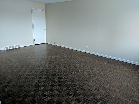 Living room, door is to a shelf unit