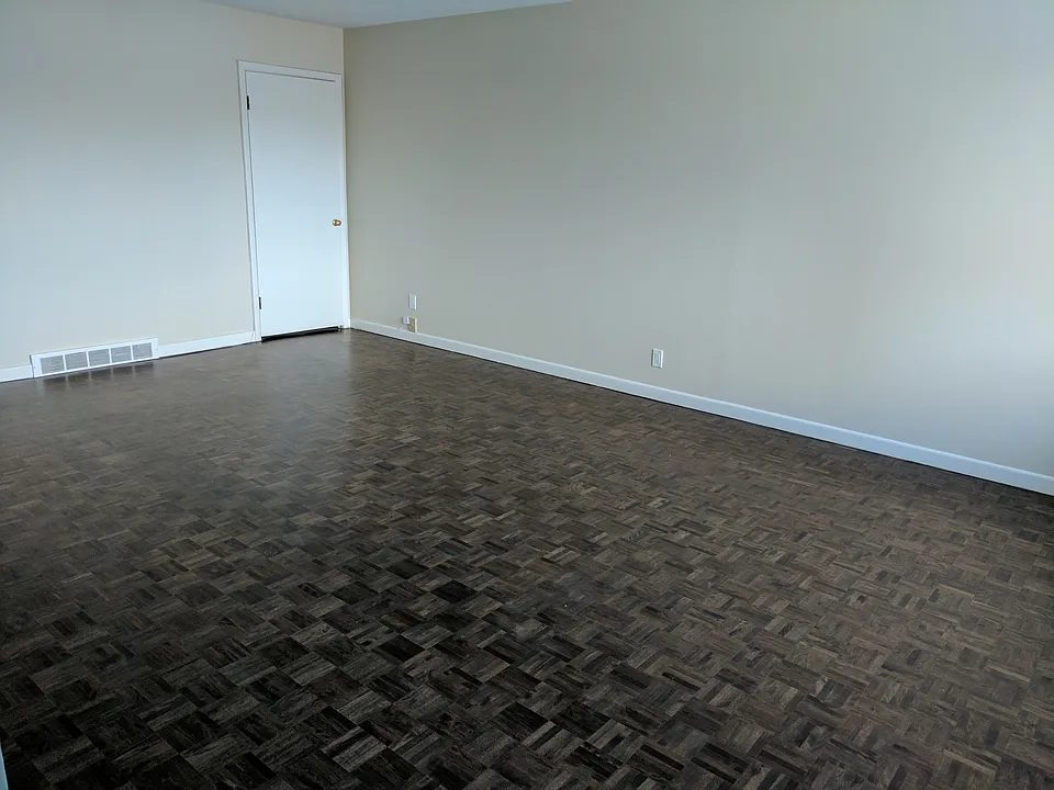 Living room, door is to a shelf unit