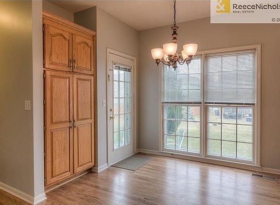 Sunny breakfast room boasts a new oil-rubbed bronze fixture.  Note large storage pantry.