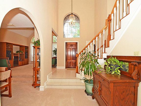 Beautiful bright tile entry with soaring ceilings welcomes you