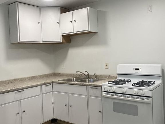 New kitchen with stove and refrigerator