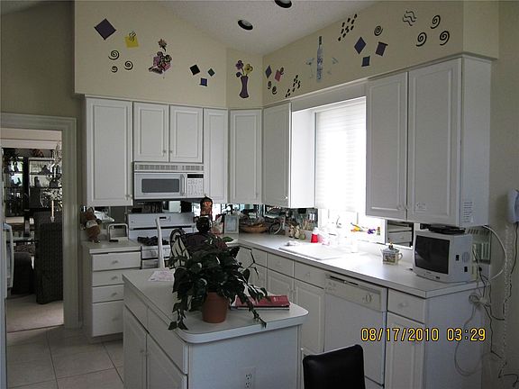 White Kitchen with Center Island and Separate Eating Area