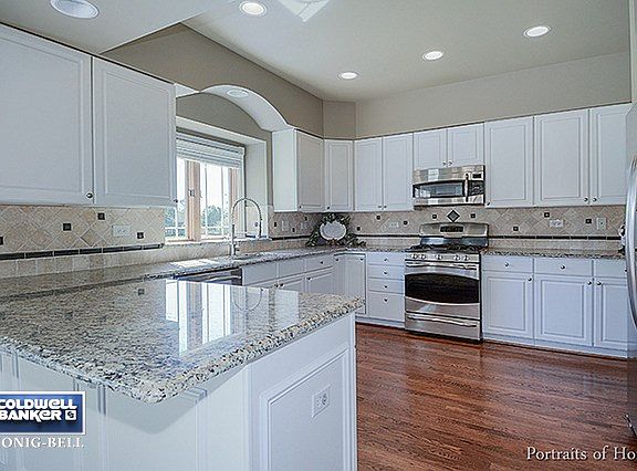 Updated granite countertops, stainless appliances and stylish backsplash.