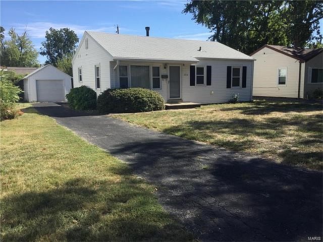 Charming bungalow style home with extra long driveway and 1 car detached garage.
