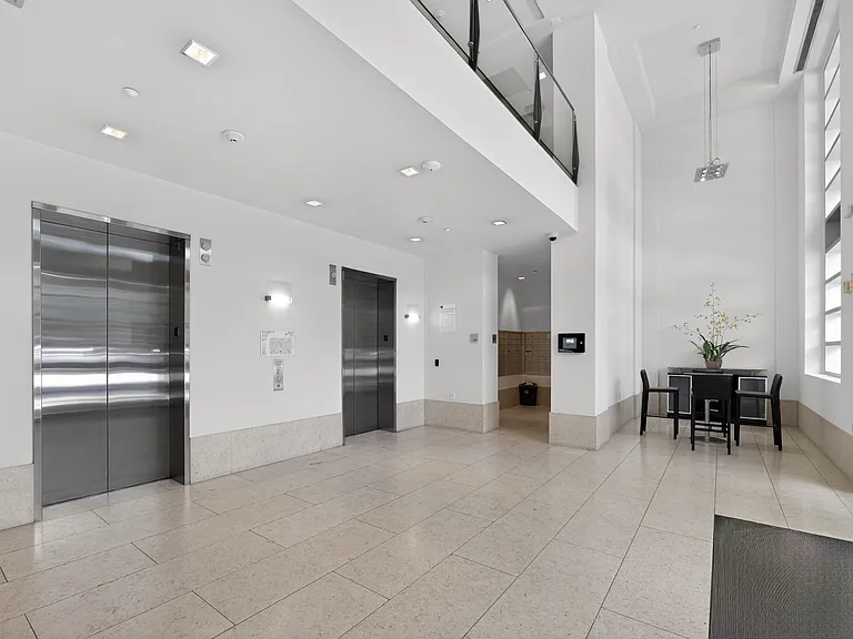 Bright lobby with controlled-access entry, controlled-access elevators, high ceilings, and 2 modern seating areas.