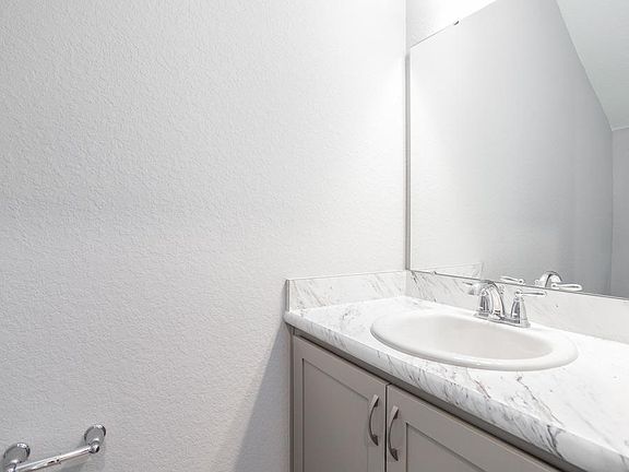 A convenient downstairs powder room serves guests - Seabrooke ll home plan by Highland Homes