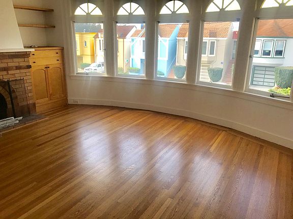 Five bay windows in living room open to outside world