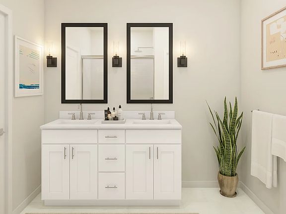 Primary bath with black-framed mirrors