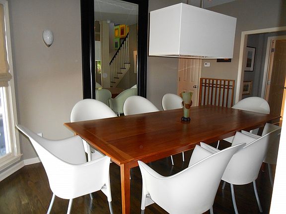 Up to date dining room light fixture enhances this dining area.