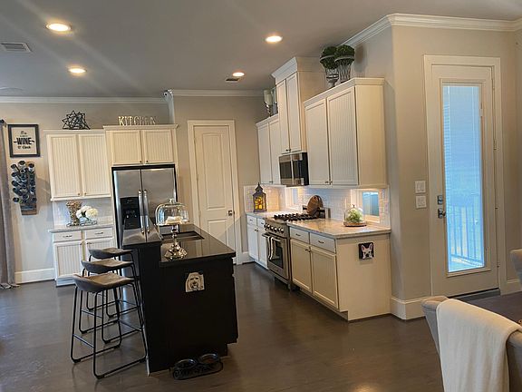 Open Kitchen with duel level dining island features natural stone countertops.