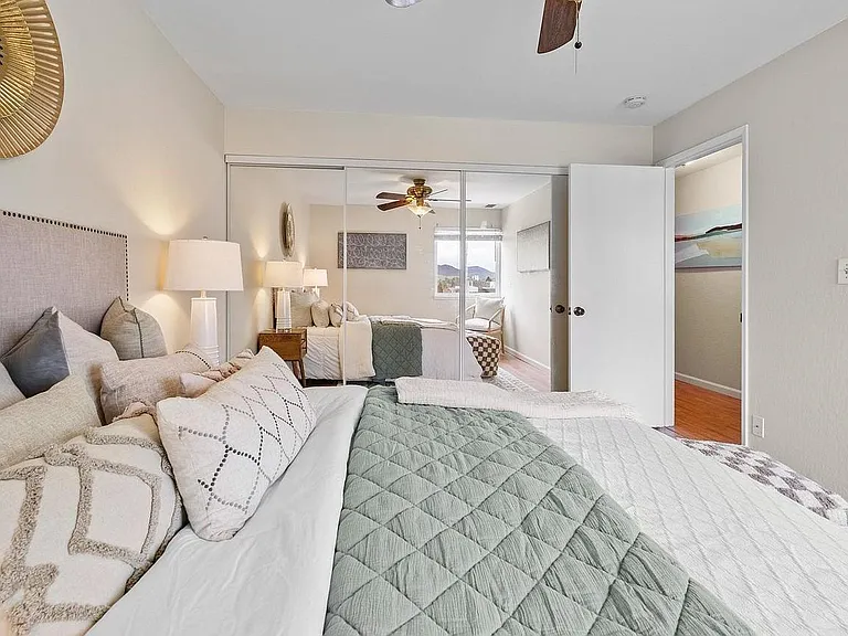 Master bedroom with ceiling fan and 9 foot closet