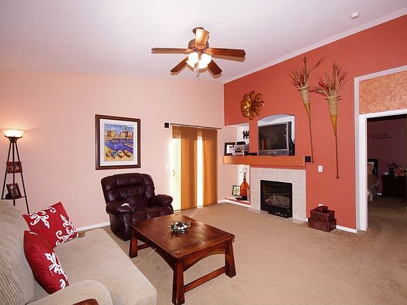 The living room has ceiling fan.  Door to master bedroom to the right.
