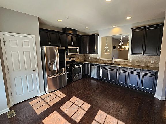 Large kitchen with ample counter space and eat-in versatility_allowing the adjoining living area to function as a dedicated dining room or expanded gathering space