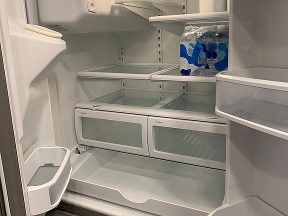 33" extra-large Kitchenaide refrigerator/freezer with double french doors on top, auto ice maker that serves water and ice through the door.