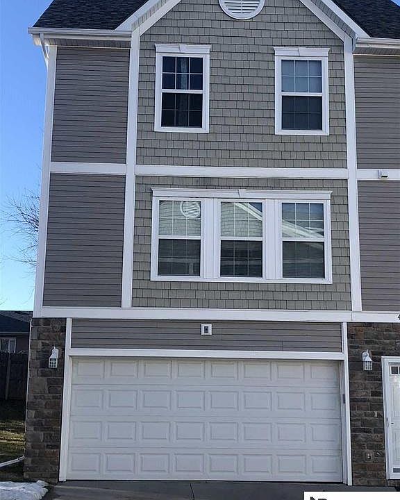 Front of home featuring 2 car garage and 2 stall driveway.