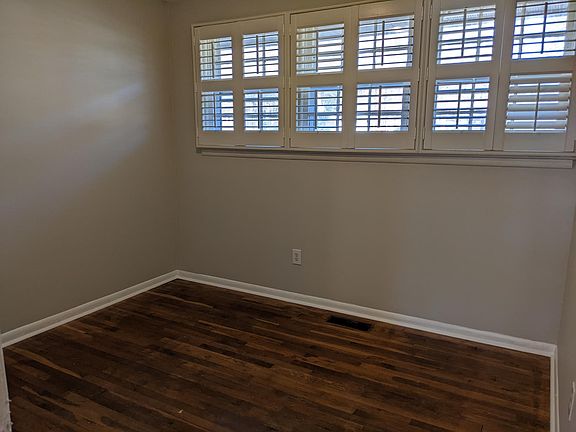 Bedroom #3 with fresh paint, new light, and newly refinished oak hardwood floors!