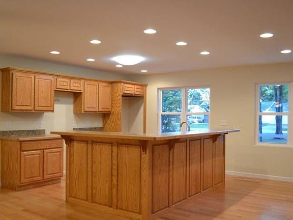 Take a look at your brand new custom kitchen. With custom oak cabinets, you will be sure to feel the quality when using this kitchen. Notice the island has a very large bar that could easily sit 6-8 people, a great place to gather the family while cooking a meal.