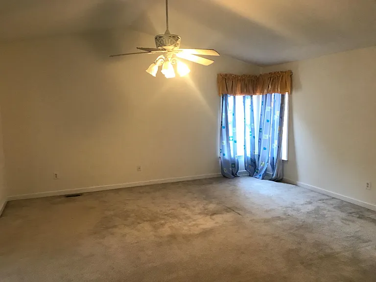 Valuted-Ceiling master suite with separate His and Her closets.