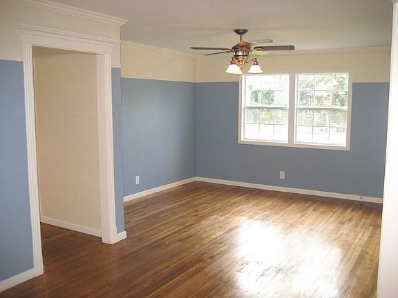 Formal Den shows off beautiful solid oak floor, crown molding, and custom trim