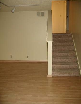 Lower level living room and stairs leading to the bedrooms