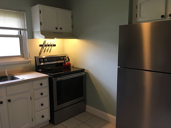 Brand new 5-burner, glasstop range and large refrigerator