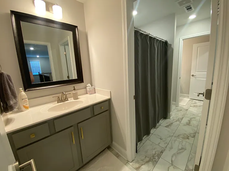 Jack & Jill bathroom. Shared tub/shower and toilet. Sink is private with doors.