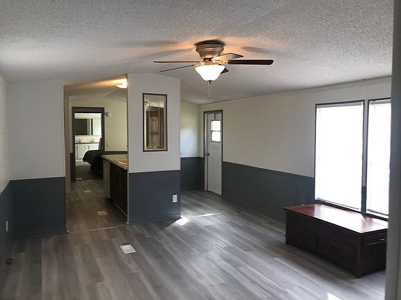 Living room and kitchen viewed from just inside the front door.