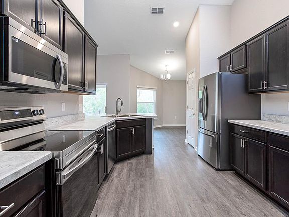 Your new kitchen includes beautiful finishes and is open to the dining cafe - New home for sale in O