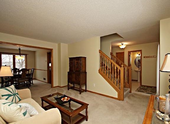Bright and sunny, the formal living and dining rooms sit adjacent to the entryway.