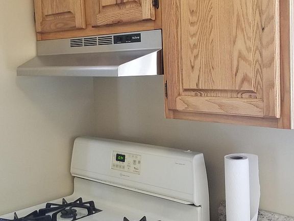 New stainless range hood with gas stove