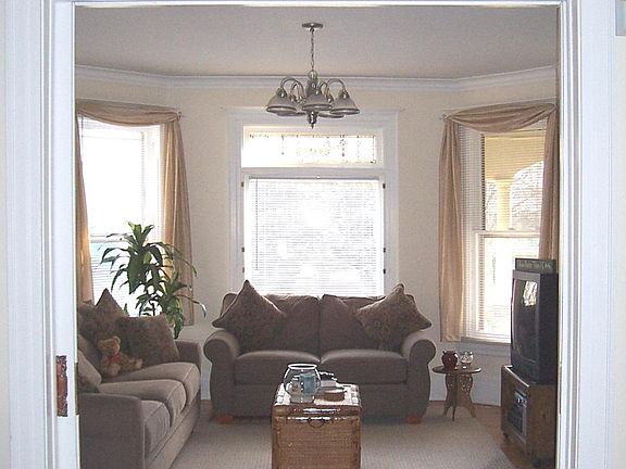 Front room with pocket doors to rest of unit and built in bookcases