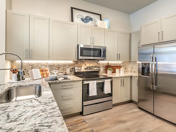 Stunning kitchens with french door stainless steel refrigerators, granite countertops, tile backsplash, and custom cabinetry