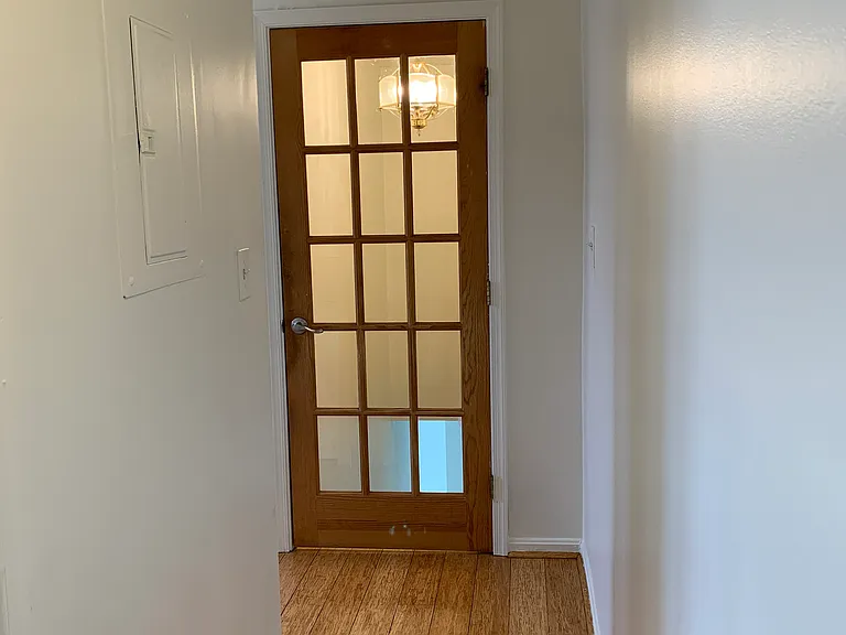 Hallway leading back to entry door, kitchen and living room.