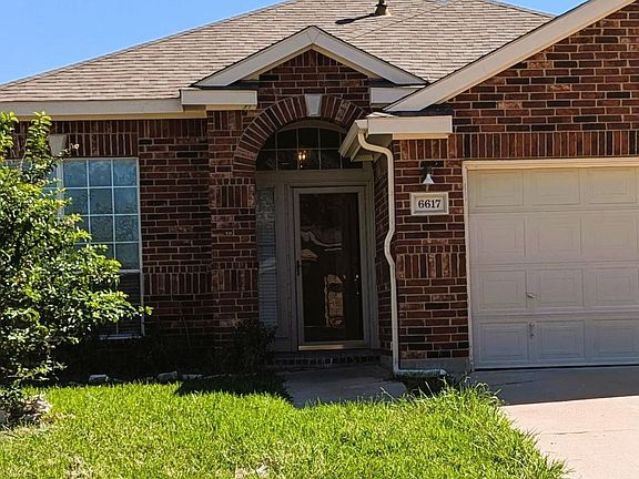 Framed by rich brick in a stately arc, the front porch is a warm welcome to friends and family.