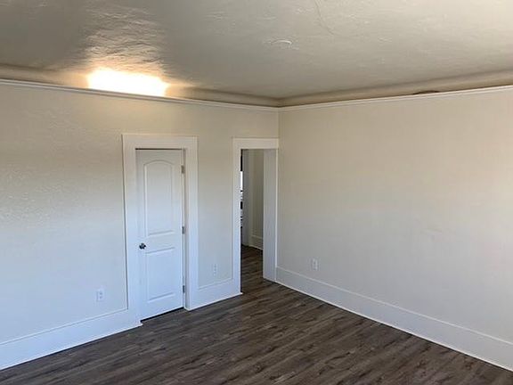 Living room, view to closet and hallway.