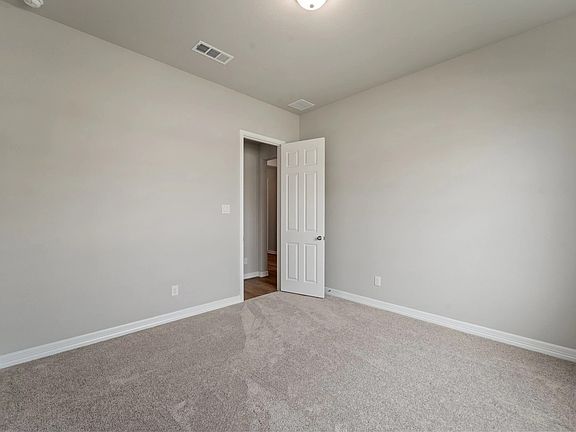 An additional view of the third bedroom with walk in closet.