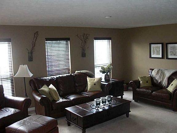 Large living room with neutral paint and 3 windows. 