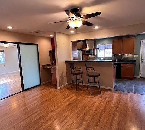 Upon entry, view of dining area with breakfast bar top and kitchen in background.