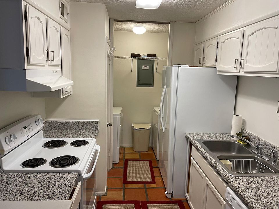 Kitchen with granite countertops & indoor laundry space.