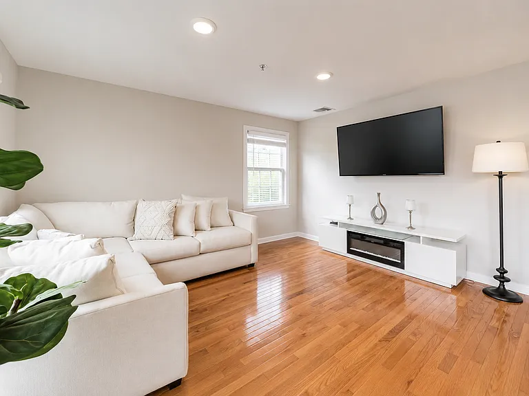 Comfortable living room with beautiful hardwood floors and recessed lighting