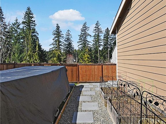 Above ground pool stays with home. Sun drenched garden space.