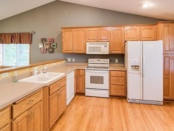 Main floor is open and bright with vaulted ceiling and recessed lighting.  This home has knockdown ceilings throughout.