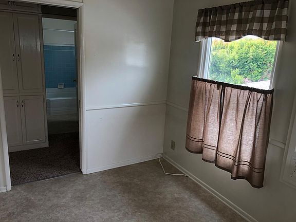 Plenty of room in kitchen for a table and chairs Also a in wall ironing board