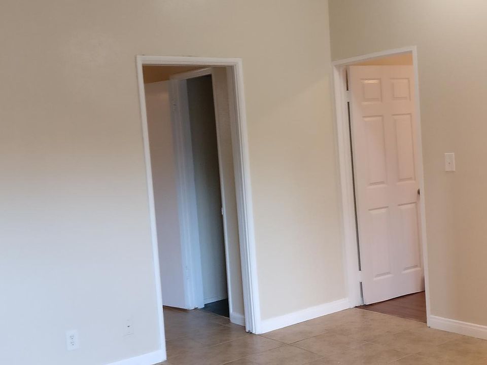 High ceiling living room with nice new tile in the entry, l