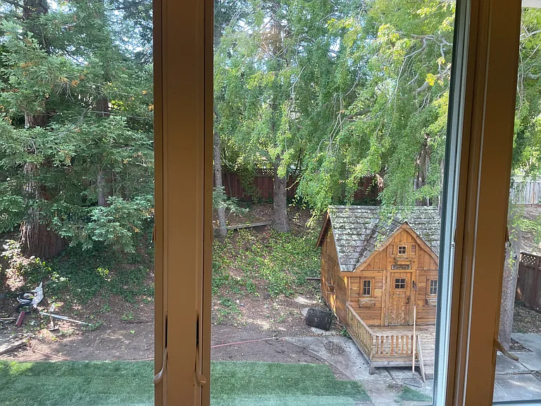 Vieew of the backyard with a bonus playhouse/storage