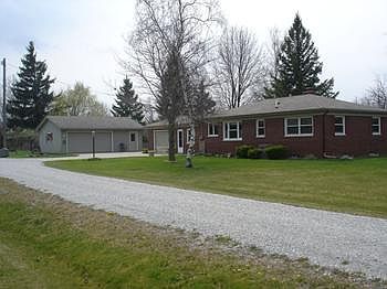 This is a rear view of the home and private entry drive with the bonus 2-12 car garage and heated workshop