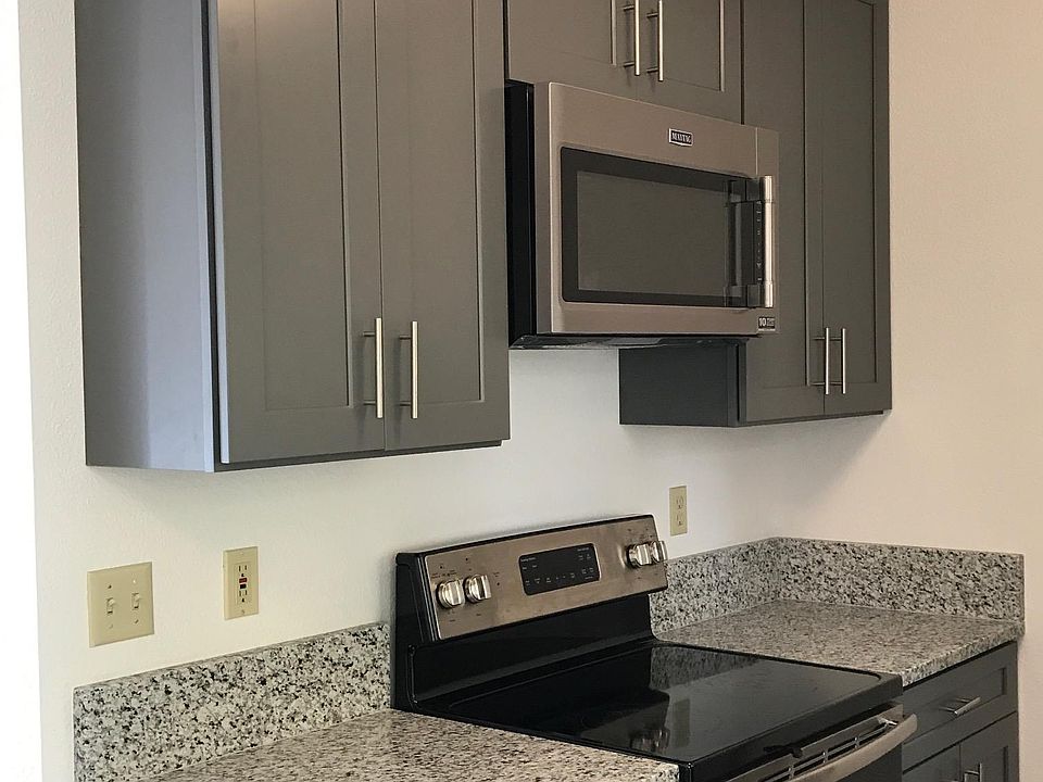 New kitchen with granite countertop. Microwave and ceramic t