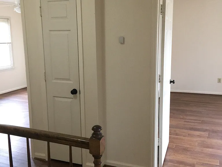 Hall area upstairs with linen closet
