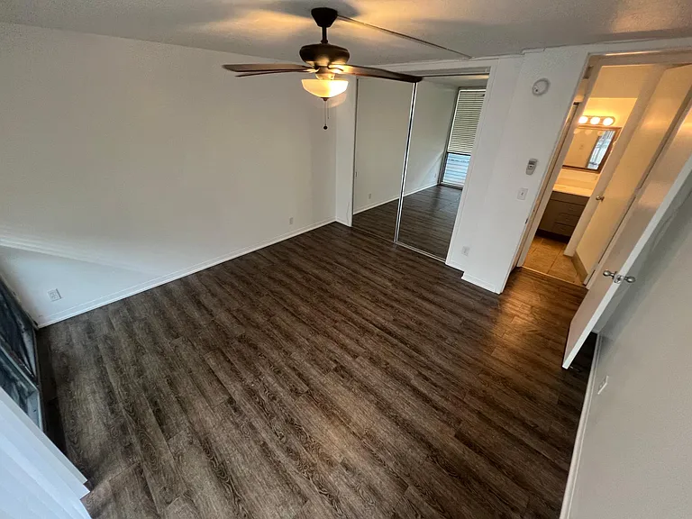 Large primary bedroom with large closet & ceiling fan
