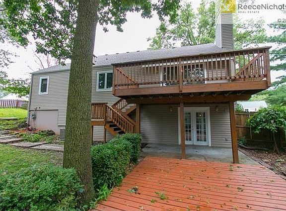 The back of the home with 2 decks.  The upper level has a sliding glass door, lower level has French doors.